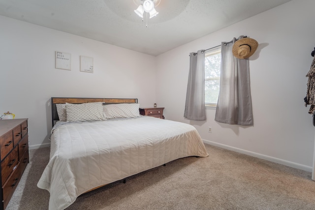 bedroom with carpet floors, ceiling fan, baseboards, and a textured ceiling