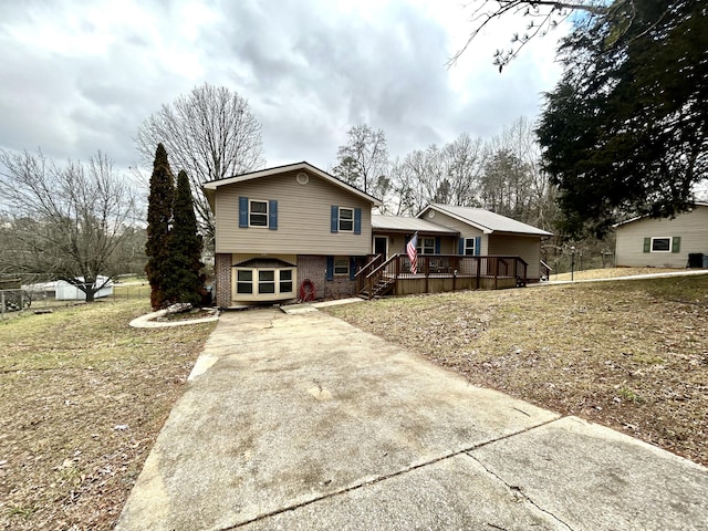 split level home with concrete driveway and brick siding