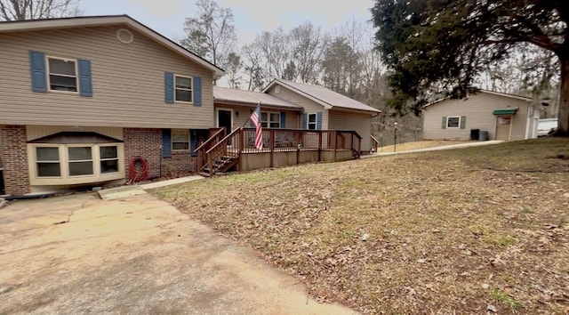 back of house featuring a deck and a yard