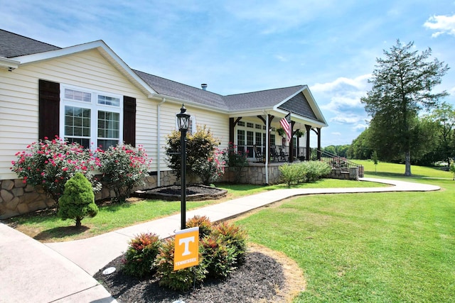 view of front facade with a front yard and a porch