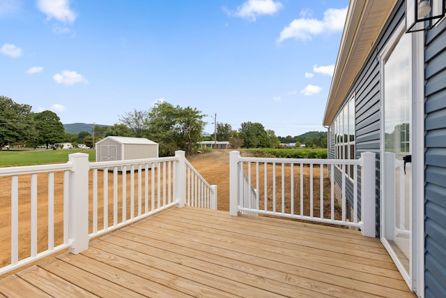 wooden terrace featuring a storage unit