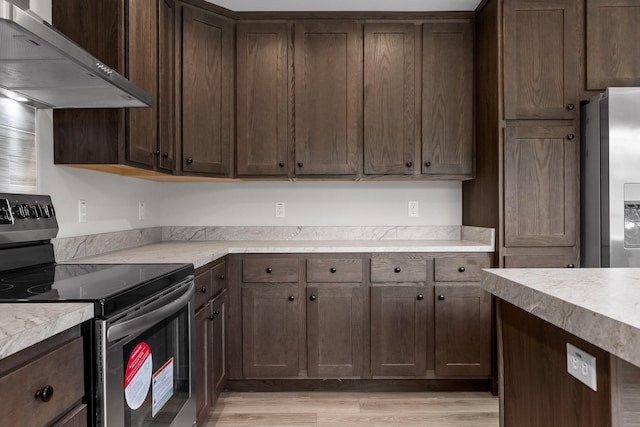 kitchen with extractor fan, appliances with stainless steel finishes, light wood-type flooring, and dark brown cabinets