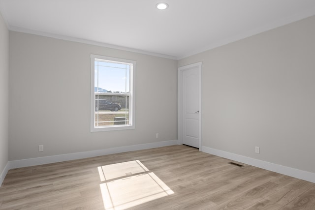 unfurnished room with light wood-type flooring and ornamental molding