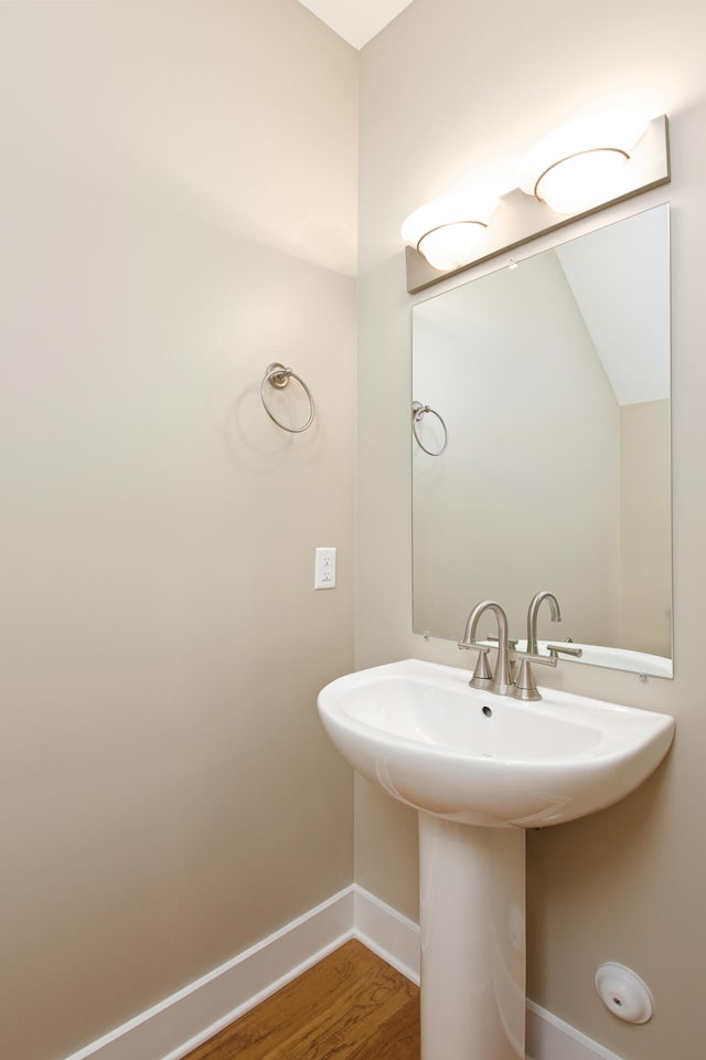 bathroom with wood-type flooring and sink