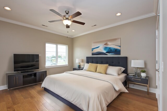 bedroom with crown molding, ceiling fan, and dark hardwood / wood-style flooring