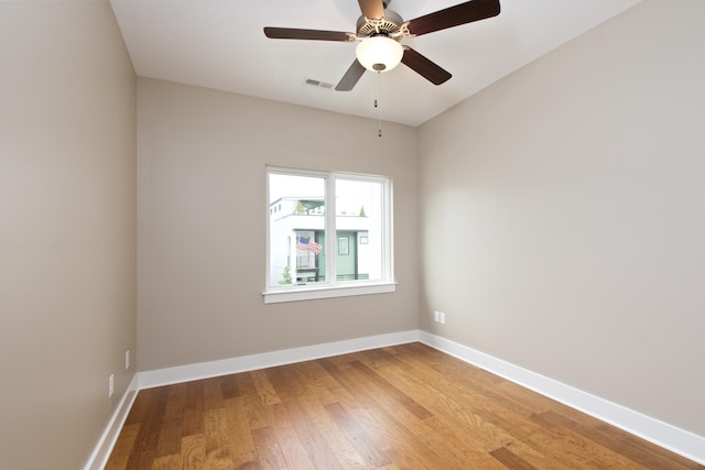 empty room featuring ceiling fan and hardwood / wood-style flooring