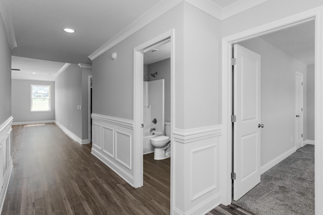 corridor with dark hardwood / wood-style floors and ornamental molding