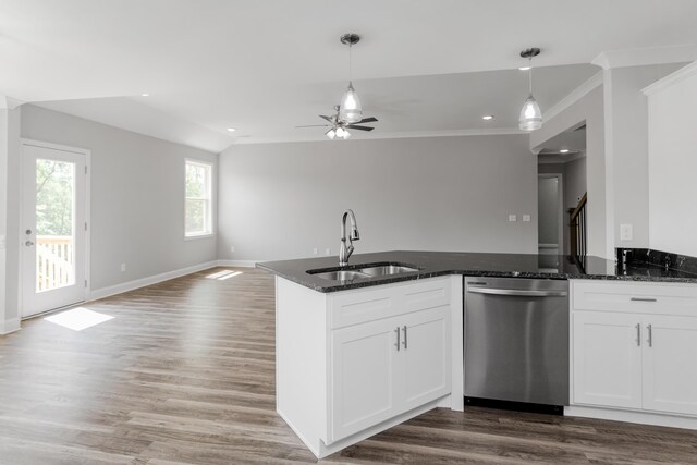 kitchen featuring dark stone countertops, white cabinets, decorative light fixtures, and stainless steel dishwasher