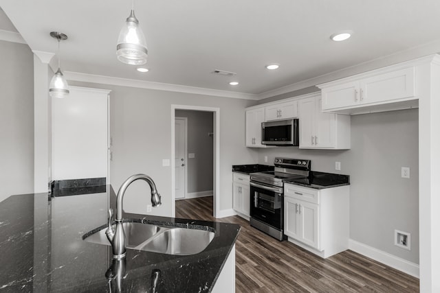 kitchen with white cabinets, appliances with stainless steel finishes, sink, and decorative light fixtures