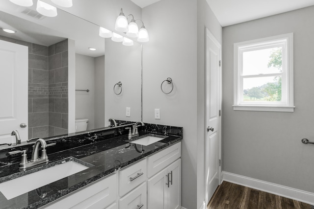 bathroom with hardwood / wood-style flooring, toilet, and vanity