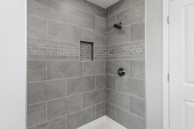 bathroom with a tile shower