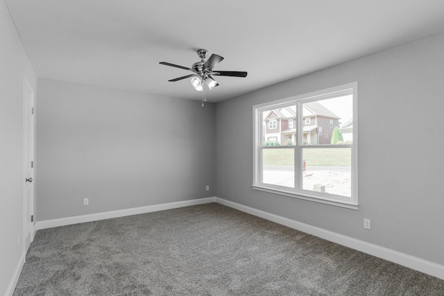 unfurnished room with ceiling fan and carpet