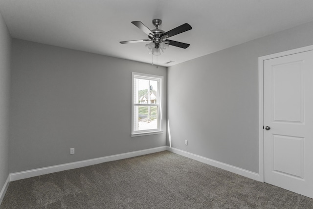 carpeted spare room with ceiling fan