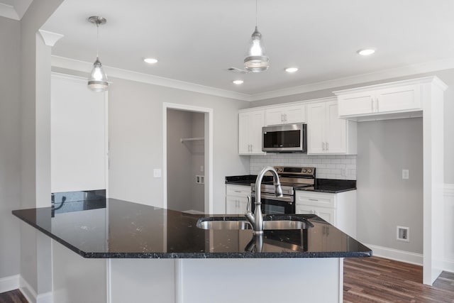 kitchen with dark hardwood / wood-style flooring, sink, stainless steel appliances, hanging light fixtures, and white cabinets