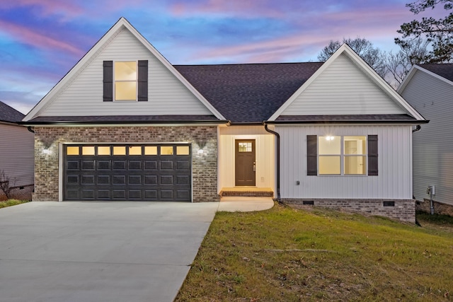 view of front facade with a garage and a yard