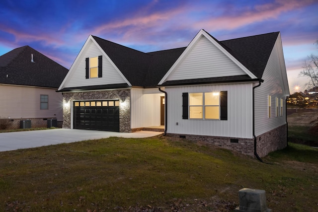 modern farmhouse featuring a garage, cooling unit, and a lawn