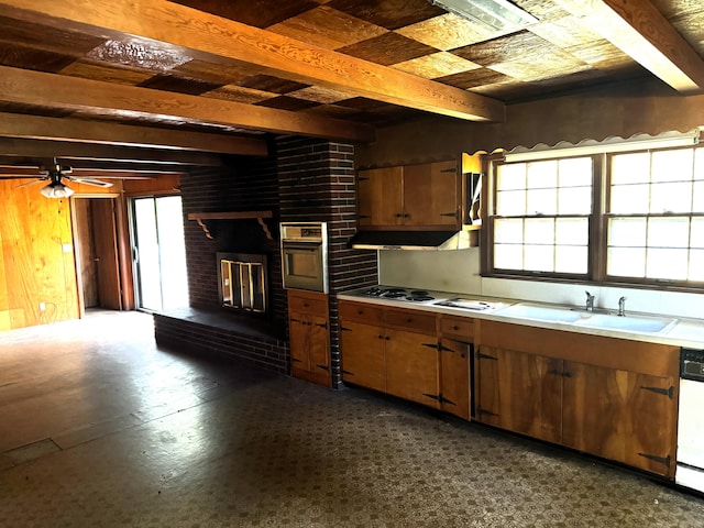 kitchen featuring ceiling fan, exhaust hood, sink, white appliances, and beamed ceiling