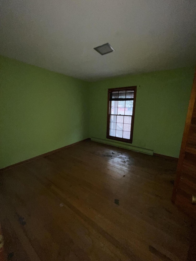 spare room with dark hardwood / wood-style flooring