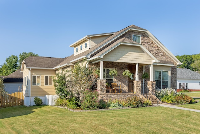 craftsman house with covered porch and a front lawn