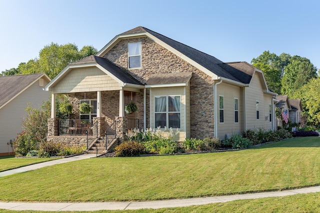 craftsman inspired home featuring a porch and a front lawn