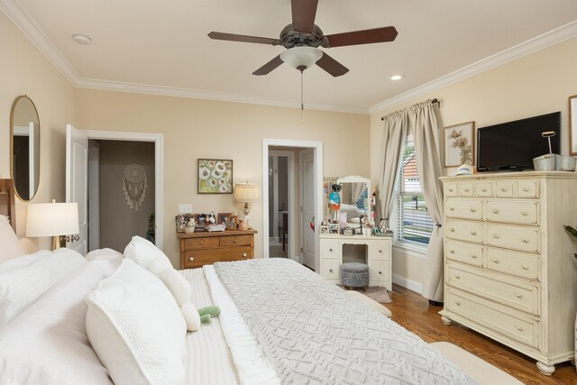 bedroom featuring ceiling fan, dark hardwood / wood-style flooring, and ornamental molding