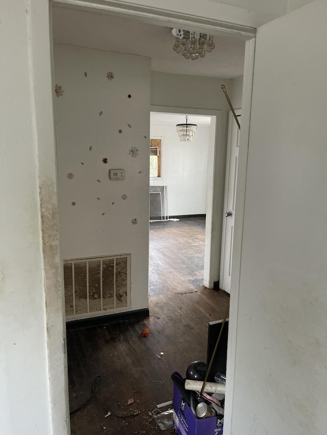 hallway with visible vents and wood finished floors