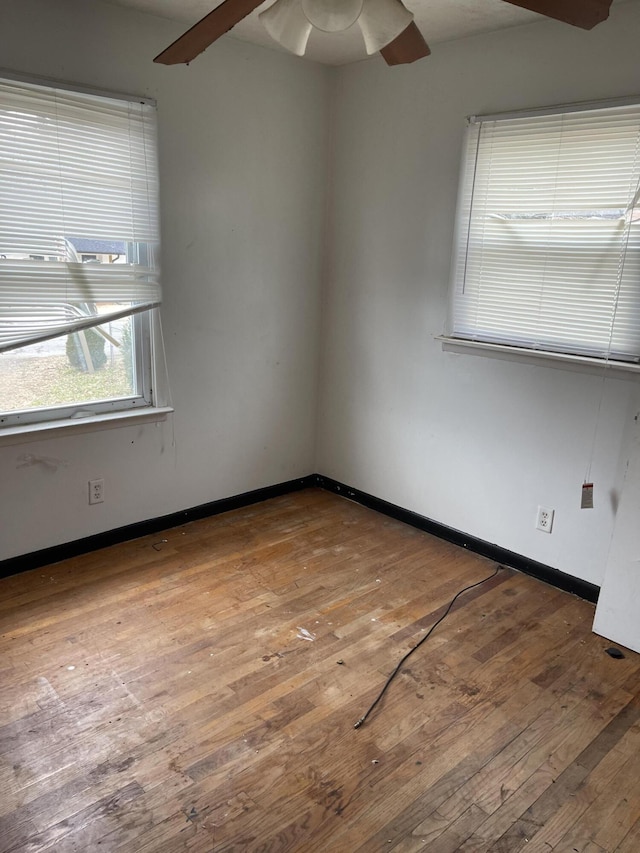 unfurnished room featuring wood finished floors and baseboards