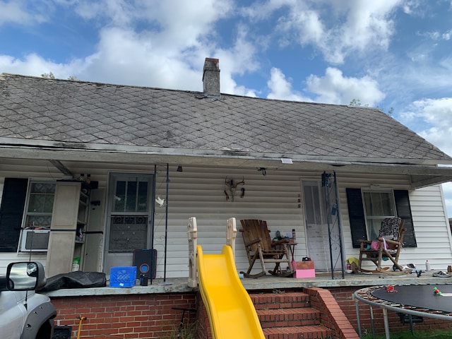 rear view of property with a porch