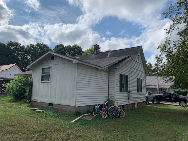 view of property exterior with a lawn