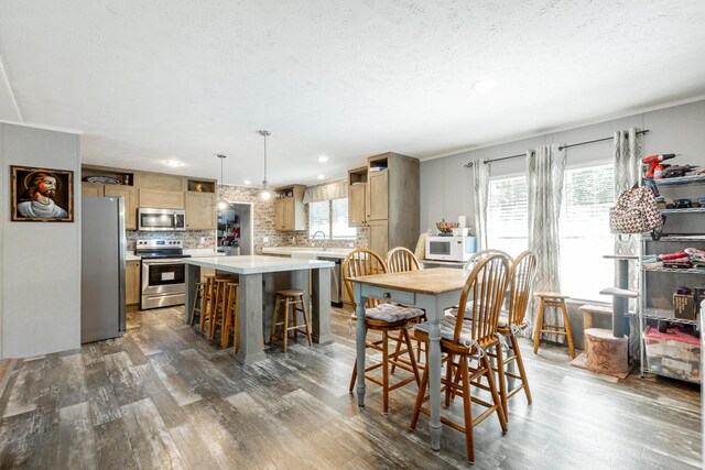 dining space featuring hardwood / wood-style flooring and a healthy amount of sunlight