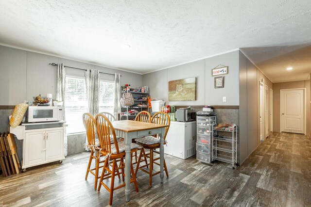 dining area featuring crown molding, a textured ceiling, and dark hardwood / wood-style floors