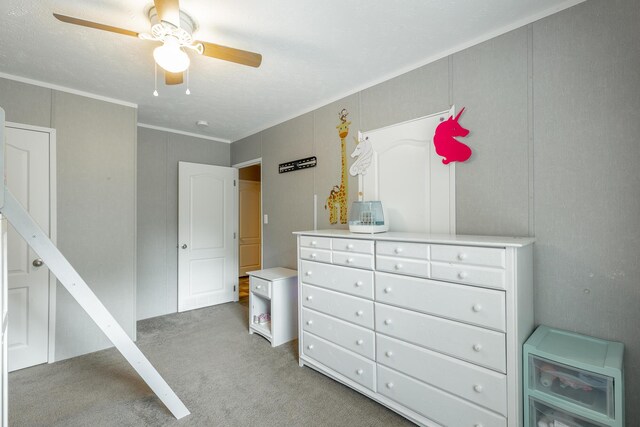 bedroom with ceiling fan, ornamental molding, and light carpet