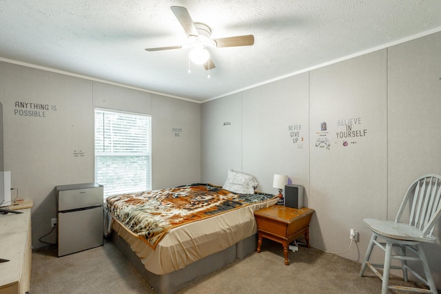 bedroom featuring a ceiling fan, light carpet, freestanding refrigerator, a textured ceiling, and ornamental molding