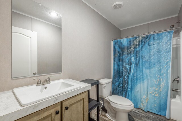 full bathroom featuring toilet, crown molding, vanity, shower / bath combination with curtain, and hardwood / wood-style flooring