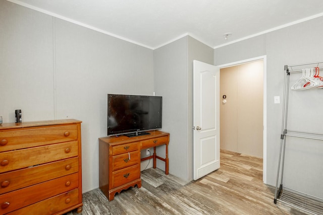 bedroom with crown molding and light wood-style floors
