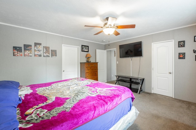 bedroom with ornamental molding, carpet, and a ceiling fan