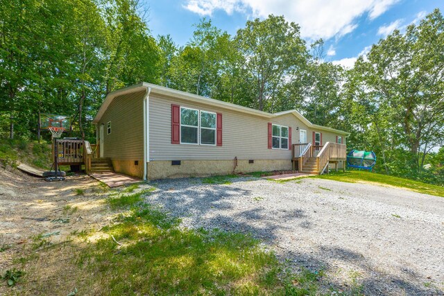 manufactured / mobile home with a wooden deck