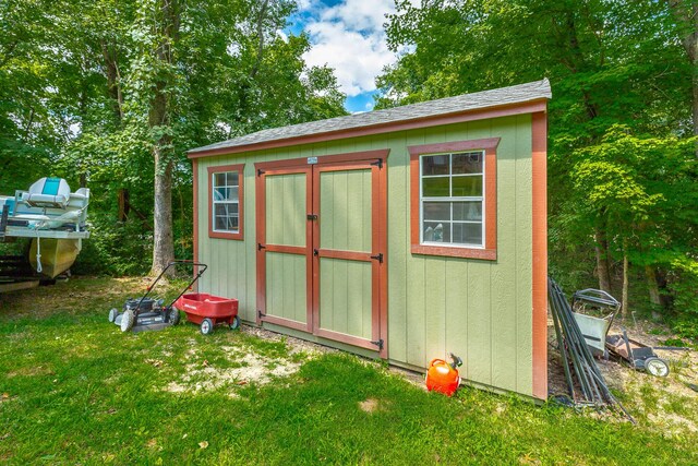 view of outbuilding featuring a lawn