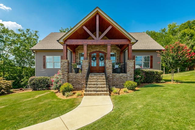 craftsman house with a front yard and a porch