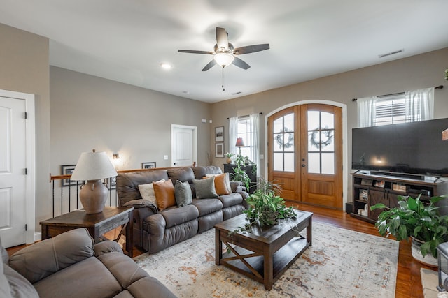 living room with ceiling fan, wood-type flooring, and french doors