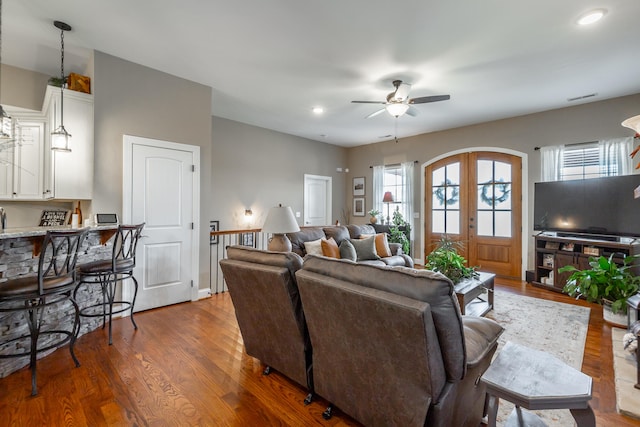 living room with wood-type flooring and ceiling fan