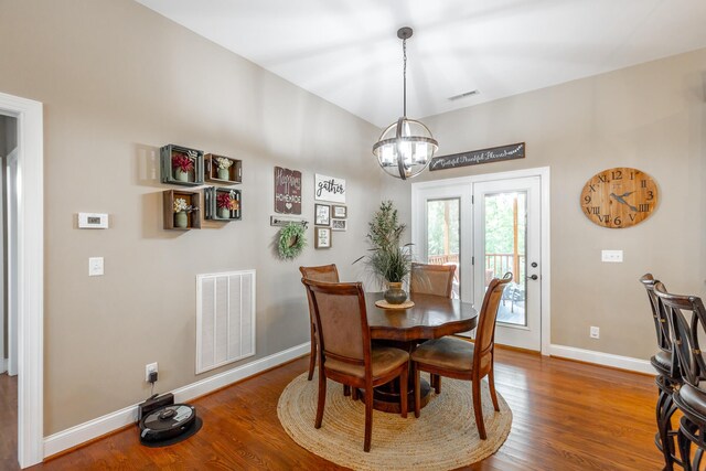 dining room with french doors, an inviting chandelier, and dark hardwood / wood-style floors