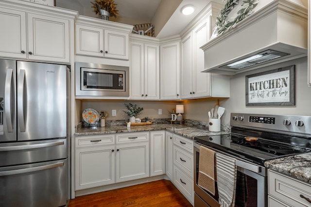 kitchen with custom exhaust hood, white cabinets, stainless steel appliances, and dark hardwood / wood-style floors