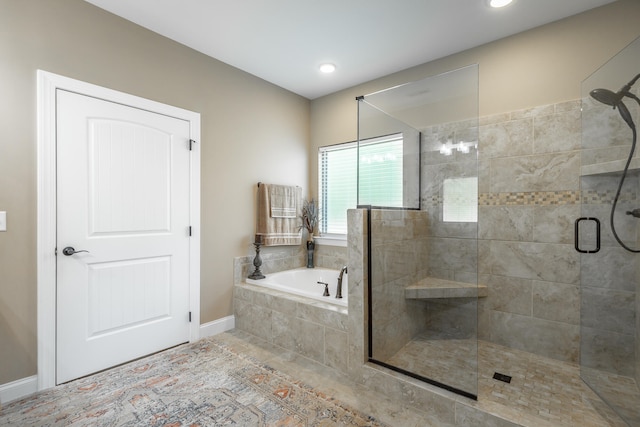 bathroom featuring plus walk in shower and tile patterned flooring