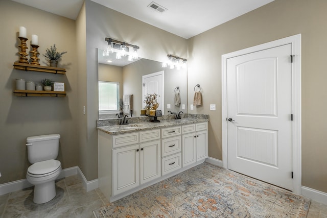 bathroom featuring tile patterned floors, toilet, and vanity