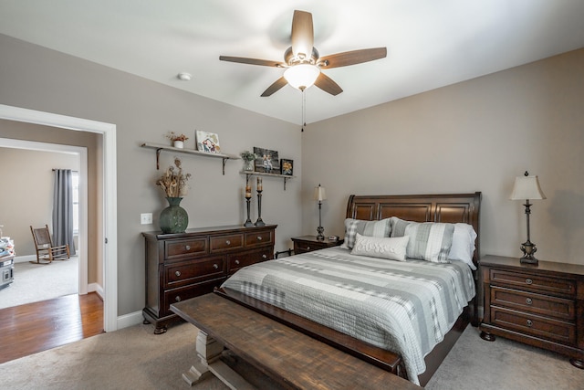 bedroom with ceiling fan and light carpet