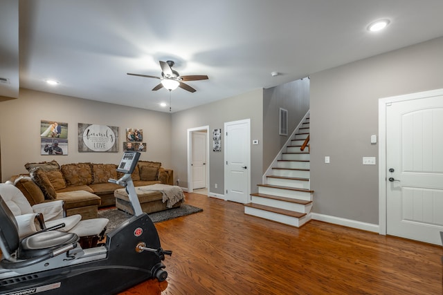 living room with ceiling fan and dark hardwood / wood-style floors