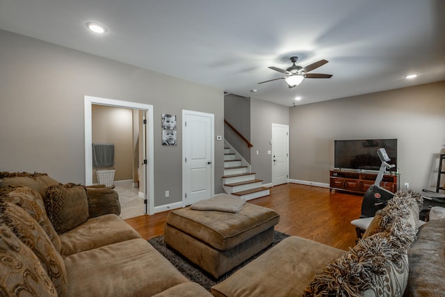 living room featuring ceiling fan and hardwood / wood-style flooring