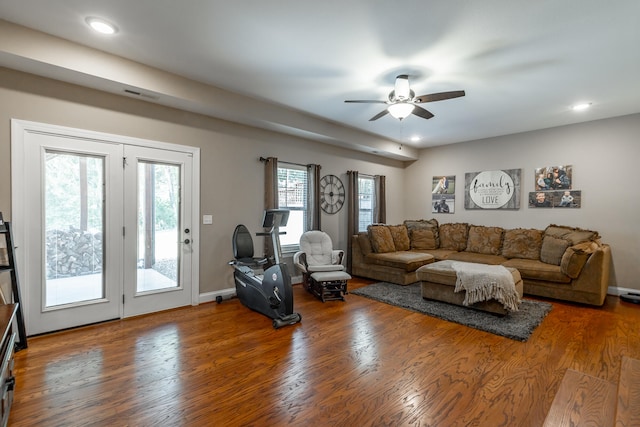 living room with ceiling fan and dark hardwood / wood-style floors