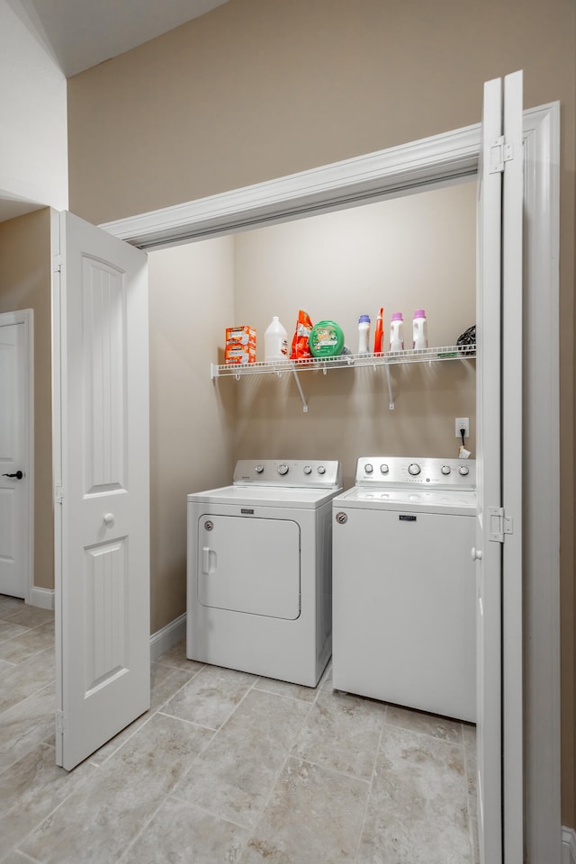 clothes washing area featuring washing machine and clothes dryer